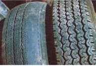 Note the good, uniform tread on the tire to the right, versus the uneven wear — probably caused by poor wheel alignment — exhibited by the doughnut to the left.